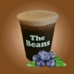 A refreshing iced coffee from The Beans, featuring a blend of coffee and blueberry, served in a clear cup. This drink is one of the popular offerings on the Bunch of Beans Menu at South Islamabad Eats.