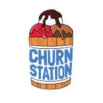 Churn Station logo featuring an ice cream cone with two scoops—one red and one brown—drizzled with chocolate sauce. The logo is accompanied by the words 'Churn Station' in bold blue letters, set against a wooden barrel backdrop. Churn Station offers a variety of frozen treats and beverages as part of South Islamabad Eats, including rich ice creams, indulgent shakes, hot chocolates, and sundaes from the Churn Station menu.