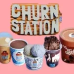 Churn Station logo featuring an ice cream cone with two scoops—one red and one brown—drizzled with chocolate sauce. The logo is accompanied by the words 'Churn Station' in bold blue letters, set against a wooden barrel backdrop. Churn Station offers a variety of frozen treats and beverages as part of South Islamabad Eats, including rich ice creams, indulgent shakes, hot chocolates, and sundaes from the Churn Station menu.